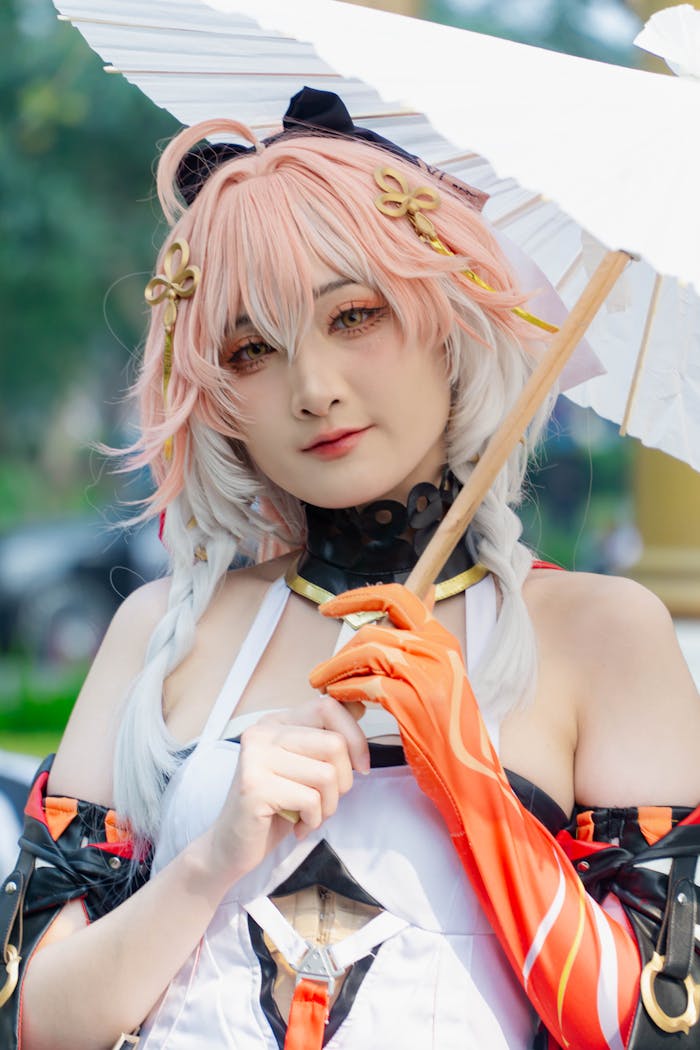 A vibrant cosplay character holding a white parasol in an outdoor setting.