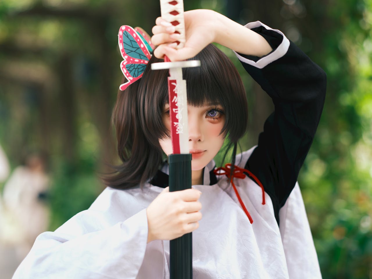 Anime-inspired character holding a sword outdoors with butterfly hairpin and vibrant costume.