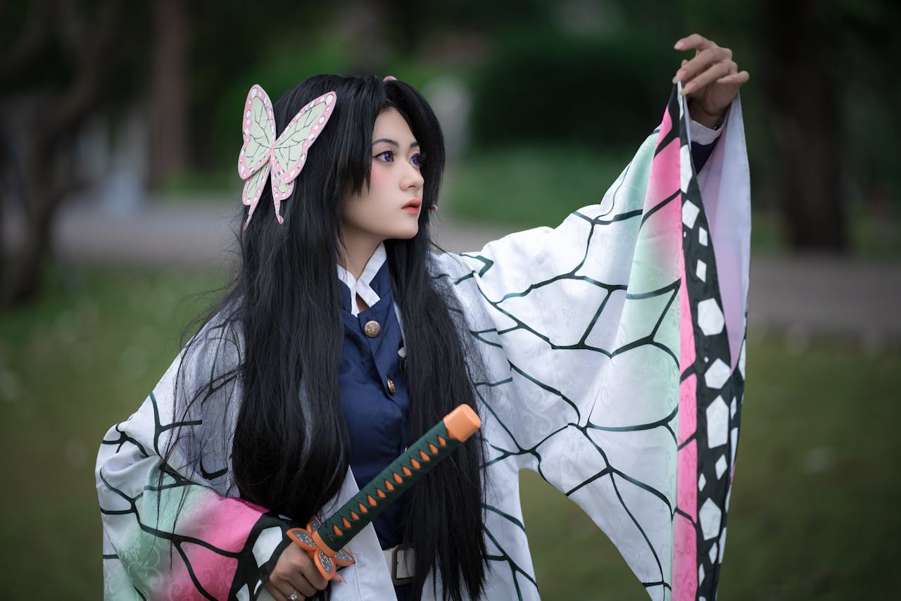 A captivating portrait of a woman in intricate cosplay attire holding a sword outdoors.